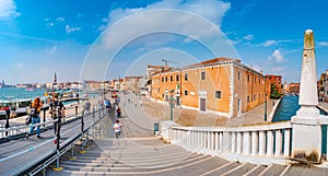 Panoramic view over busy with tourists Venice, piers, promenade embankment near old Arsenal in Venice downtown, Italy, at sunny