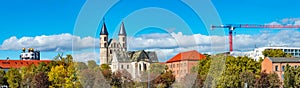 Panoramic view over Church Monastery of Our Beloved in historical downtown and park of Magdeburg at blue sky with clouds and