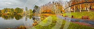 Panoramic view over city park Rotehorn and lake in Autumn golden colors at cloudy rainy day, Magdeburg, Germany