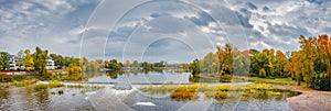 Panoramic view over city park Rotehorn, old Elbe river and anti-flooding dam in Autumn golden colors at cloudy rainy day,
