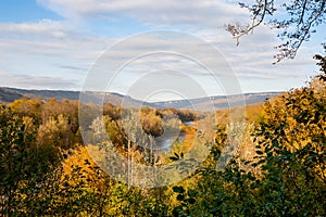 Panoramic view over colorful mountain valley with river fall sea