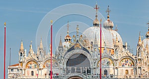 Panoramic view over decoration elements at roofs and cupolas of Basilica San Marco in Venice, Italy, at sunny day and deep blue