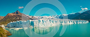Panoramic view over gigantic Perito Moreno glacier in Patagonia with blue sky and turquoise water glacial lagoon, South America,