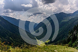 Panoramic view over the green and lush summerish Valea Rea Bad Valley, Fagaras Mountain photo