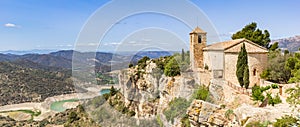 Panoramic view over the historic Santa Maria church and surrounding mountains in Siurana