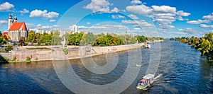 Panoramic view over historical downtown, Elbe river with a tour boat, old city in Magdeburg and Church of Saint Jochannis