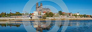 Panoramic view over Magdeburg historical downtown, Elbe river and the cathedral in early Autumn at blue sky and sunny day,