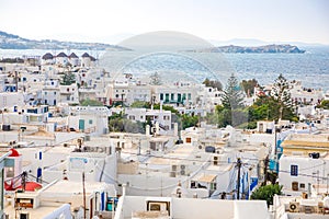 Panoramic view over Mykonos town with white architecture and cruise liner in port, Greece