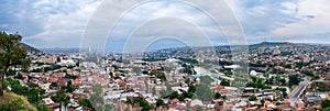 Panoramic view over old town and modern architecture of Tbilisi, Georgia. Cityscape of Mtkvari or Kura river, Cathedral