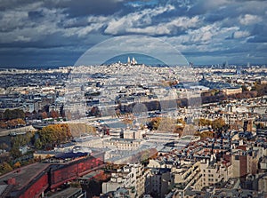 Panoramic view over the Paris city to the Sacre Coeur de Montmartre basilica on the hill, France. Autumn parisian cityscape