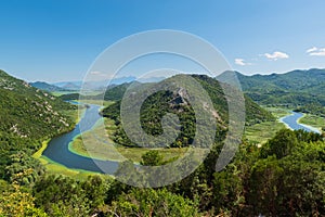 Panoramic view at Pavlova Strana on the river of Crnojevi?a flowing through green lands to Lake Skadar