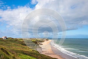 Panoramic view of people walking on Whiterocks Beach photo