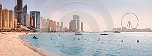 Panoramic view of the Persian Gulf beach and Bluewaters Island with the worlds famous largest Ferris wheel Dubai Eye and numerous