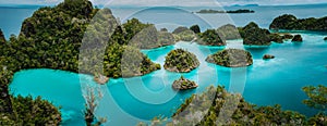 Panoramic view Pianemo Islands, Blue Lagoon with Green lush karst lime stone Rockes, Raja Ampat, West Papua. Indonesia