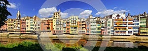 Panoramic view of the picturesque colorful houses next to the Onyar River as it passes through the old city of Girona