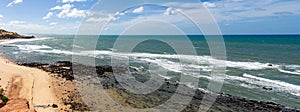 Panoramic view of Pipa beach in Brazil. The sea embraces the rocks of the coast. A Bay of crystal clear waters