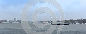 panoramic view. pleasure boats floating on the river early in the spring. In the background the city and the bridge over the rive