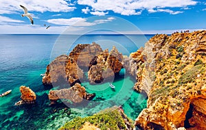 Panoramic view, Ponta da Piedade with seagulls flying over rocks near Lagos in Algarve, Portugal. Cliff rocks, seagulls and