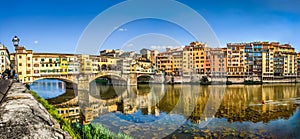 Panoramic view of Ponte Vecchio with river Arno at sunset, Florence, Italy