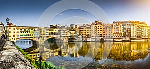 Panoramic view of Ponte Vecchio with river Arno at sunset, Florence, Italy