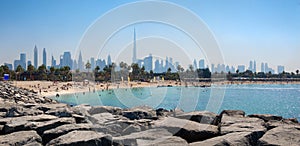 Panoramic view of popular La Mer beach in Dubai, UAE. Coastline with azure sea and high rises in background, United Arab