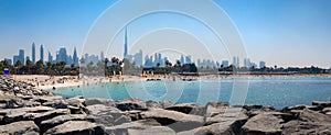 Panoramic view of popular La Mer beach in Dubai, UAE. Coastline with azure sea and high rises in background, United Arab