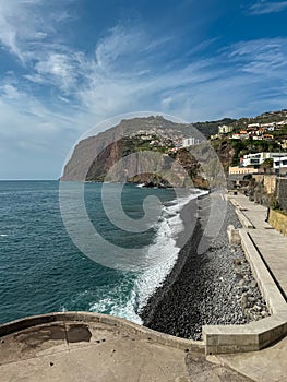 Panoramic view of Praia de Vigario in Camara de Lobos on Madeira island, Portugal, Europe. Black stone beach in Atlantic Ocean