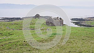 Panoramic View At Rathlin Island With Ruins Of Cobblestone House In The Foreground Against The Clea