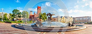 Panoramic view on Red Church or Church Of Saints Simon and Helen, Fountain at independence Square in Minsk, Belarus.