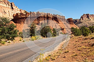 A panoramic view of the red, rugged and barren Canyonlands National Park, Utah with a dirt road weaving its way through