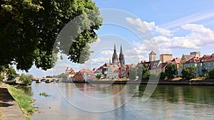 Panoramic view of Regensburg. Stone Bridge with Danube River with reflections of houses in water. Cathedral of St. Peter