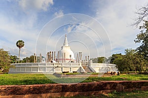 Panoramic view of restored Thuparamaya Dagoba with white bell shaped Stupa, altars, tilted vatadage pillars and Buddhist flags,