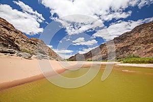 Panoramic view of rests of water during dry season near Ai-Ais Hot Springs at Fish River Canyon, Namibia photo