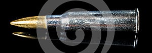 Panoramic view of a rifle bullet in a black glass background