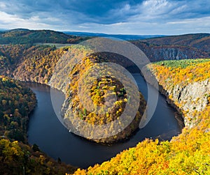 Panoramic view of river canyon with dark water and autumn colorful forest. Horseshoe bend, Vltava river, Czech republic. Beautiful