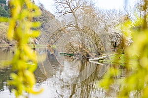 Panoramic view of river with emerald water and boats in the early spring