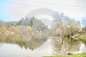 Panoramic view of river with emerald water and boats in the early spring