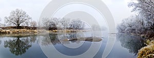 Panoramic view of river at fall misty morning