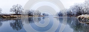 Panoramic view of river at fall misty morning