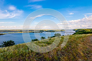 Panoramic view of the road bridge over big river and hills, slopes, steppe coast, gully, ravine on a banks