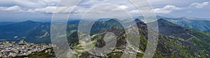 Panoramic view from Rohac peak on Western Tatra mountains or Rohace panorama with hiking trail on ridge. Sharp green