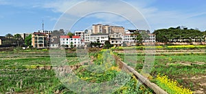 Panoramic view of rural and architectural scenery of riverside plain in spring
