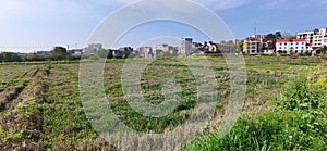 Panoramic view of rural and architectural scenery of riverside plain in spring