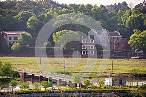 Panoramic view of rural and architectural scenery of riverside plain in spring