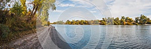 Panoramic view of the sacramento river shoreline in autumn from sandy beach