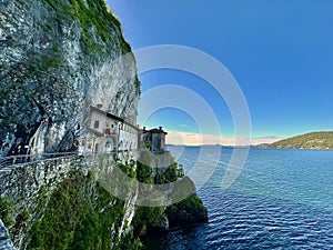Panoramic View of Santa Caterina del Sasso Hermitage Clinging to the Cliffside Overlooking the Expansive Lake Maggiore photo