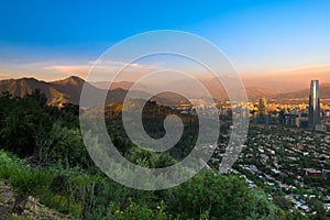 Panoramic view of Santiago with Parquemet Metropolitan park and Cerro Manquehue at sunset, Santiago