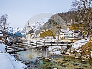 Panoramic view of scenic winter landscape in the Bavarian Alps with famous Parish Church of St. Sebastian in the village of Ramsau