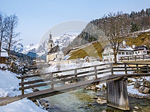 Panoramic view of scenic winter landscape in the Bavarian Alps with famous Parish Church of St. Sebastian in the village of Ramsau