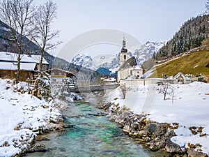 Panoramic view of scenic winter landscape in the Bavarian Alps with famous Parish Church of St. Sebastian in the village of Ramsau